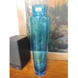 A large modern blue glass vase