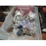 A box containing a large selection of crafting beads of various forms including polished mineral,