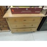 A traditional stripped pine chest of three long drawers