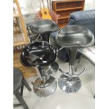 Three modern chrome and black bar stools (two matt, one gloss)