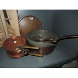 A selection of graduated copper cooking pans