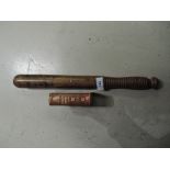 A wooden truncheon and book of hymns