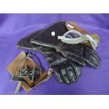 A selection of early motorcycle or car protective equipment including gloves and goggles