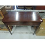 A 19th Century mahogany fold over tea table on square tapered legs
