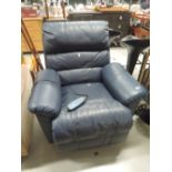 An electric recliner armchair in blue leather