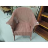 A vintage Lloyd loom tub chair in pink