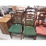 Three early 19th century elm vernacular matched dining chairs having ladder backs with rush seats
