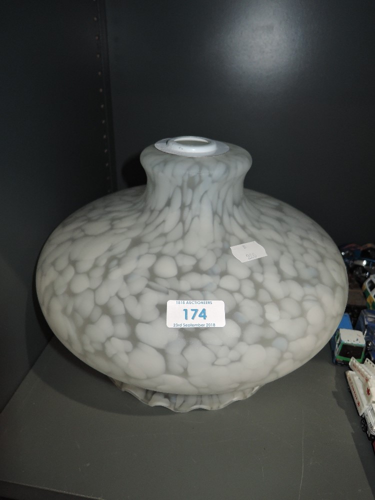 A mottled white glass light shade