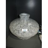 A mottled white glass light shade