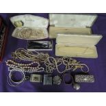 A vintage Huntley & Palmer tin containing a selection of costume jewellery and misc including