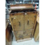 A 1930s walnut cocktail cabinet