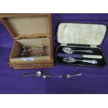 A cased child's cutlery set including HM silver spoon and fork, and a leather coated box