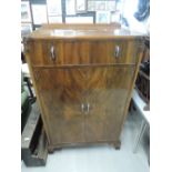 An early 20th Century mahogany and walnut bedroom cupboard