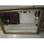 A large modern gilt framed mirror