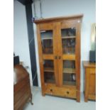 A modern hardwood bookcase/display with drawer base (matches lot 402)