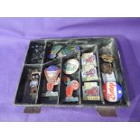 A small tray containing a selection of vintage badges including Butlins Minehead & Pwllheli, Butlins