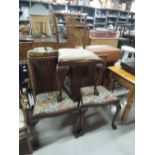A set of three early 20th Century dining chairs having feather and scroll back on cabriole legs