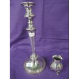 A Sheffield plate candle stick of traditional form and a small plated cream jug