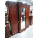 A mid Victorian mahogany wardrobe of triple/breakfront mirror door design on plinth base