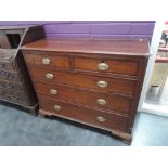 An early 19th century oak chest of two short and three long cockbeaded drawers, on bracket feet