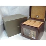A Dulwich Designs tan leather single watch rotator box with storage for three additional watches,