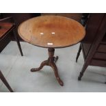 A 19th century mahogany pedestal table having circular flip top on turned column on triple splay