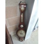 An early 19th century mahogany wheel barometer having humidity and thermometer scales, labelled