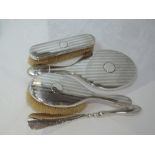 A silver four piece dressing table set having engine turned stripe decoration and plain cartouche,