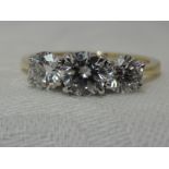 A lady's dress ring having a trilogy of diamonds, total approx 1.75ct in a 4 claw raised mount on an