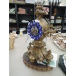 A late 19th century cast French mantel clock having blue enamel face of medieval inspiration, on