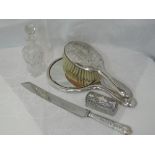 A selection of HM silver including dressing table brush, mirror and pot, bread knife and cut glass