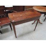 A 19th century mahogany tea table having fold over top on tapered gate legs