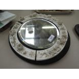 A Victorian oval wall mirror having ceramic foliate frame