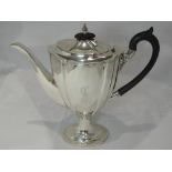 A Silver coffee pot of elongated canted urn form having initial C to front, hard wood handle and