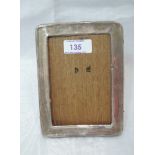 A silver photograph frame of plain rectangular form have wooden easel back, no glass, Birmingham