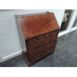 An Edwardian mahogany bureau base having line inlay decoration and drawers under flap on bracket