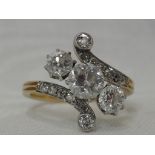 An Edwardian lady's dress ring having a trio of diamonds, approx 1ct to diamond set crossover