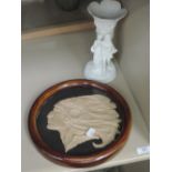 A vintage circular plaque portraying Native American Indian, in frame, and a bisque vase