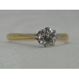 A lady's diamond solitaire dress ring, approx 0.33ct in a claw set mount on a yellow metal loop