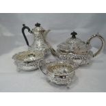 A Victorian silver four piece tea set having extensive floral embossed and repousse decoration,