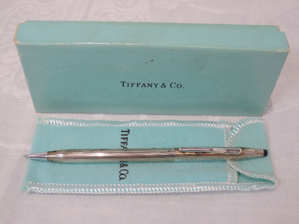 A Tiffany & Co silver ball point pen having striped decoration and stamped Cross sterling silver,