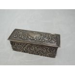 An Edwardian silver ring box of casket form having blue velvet slot lining and moulded scroll