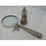 A white metal magnifying glass of Indian form having moulded palm tree and elephant decoration to