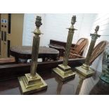 Two 20th century brass table lamps of reeded column design and a similar Corinthaian column table