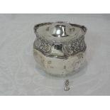 An Edwardian silver preserve pot having a gilt interior, hinged lid and moulded scroll and floral