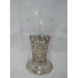 An etched glass vase having foliate decoration in a white metal cover stamped Sterling having