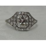 A lady's dress ring having a central cushion cut diamond, approx 1ct to diamond set surround and