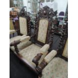 A late Victorian oak Jacobean style armchair having carved crest with twist and scroll frame and