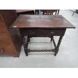 A composite 19th and 20th century oak side table in the Jacobean style having frieze drawer and