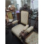 A late Victorian oak Jacobean style armchair having carved crest of boar design with twist and